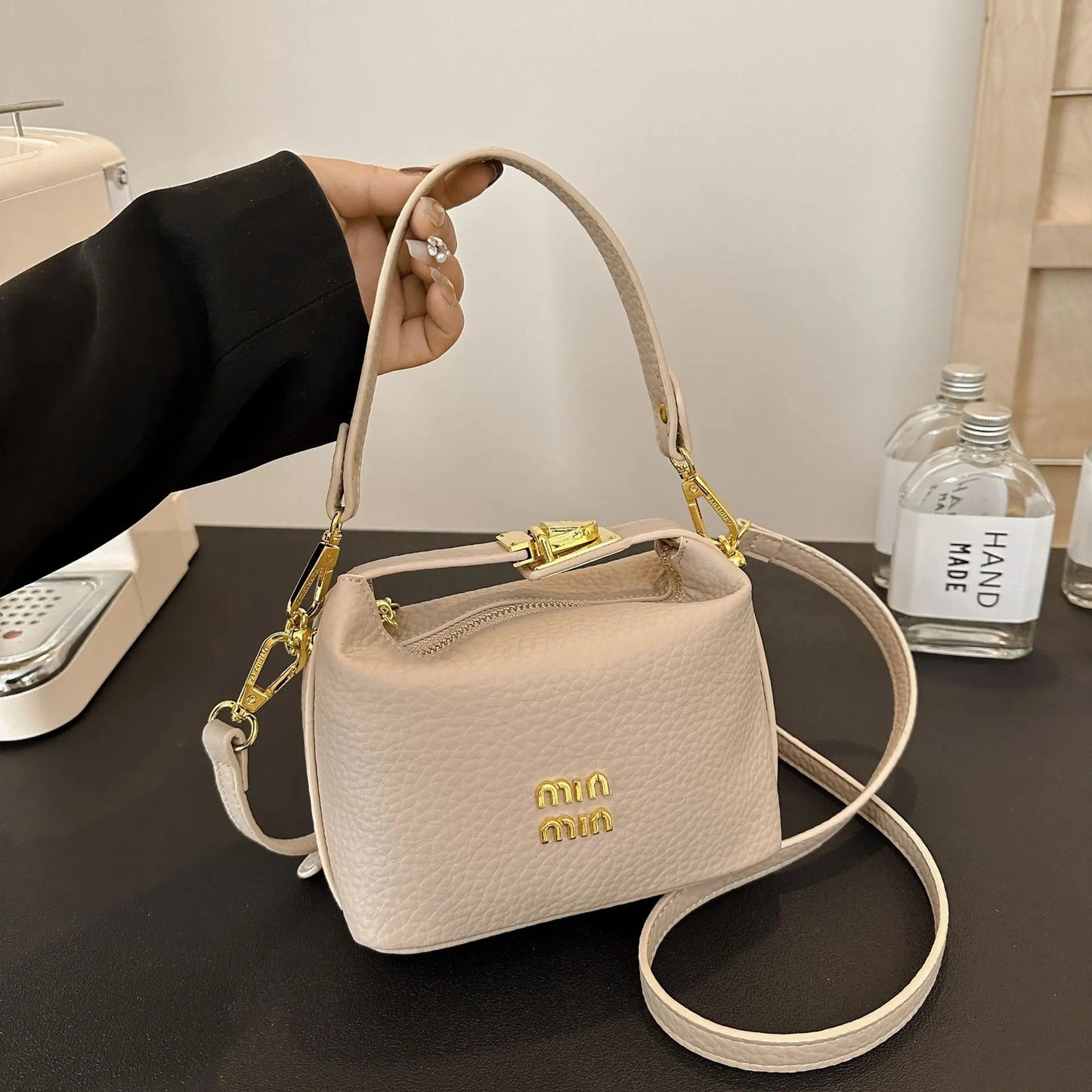 2025 Luxury high-end designer lunch box style shoulder/cross-body messenger bag with a lychee pattern .
