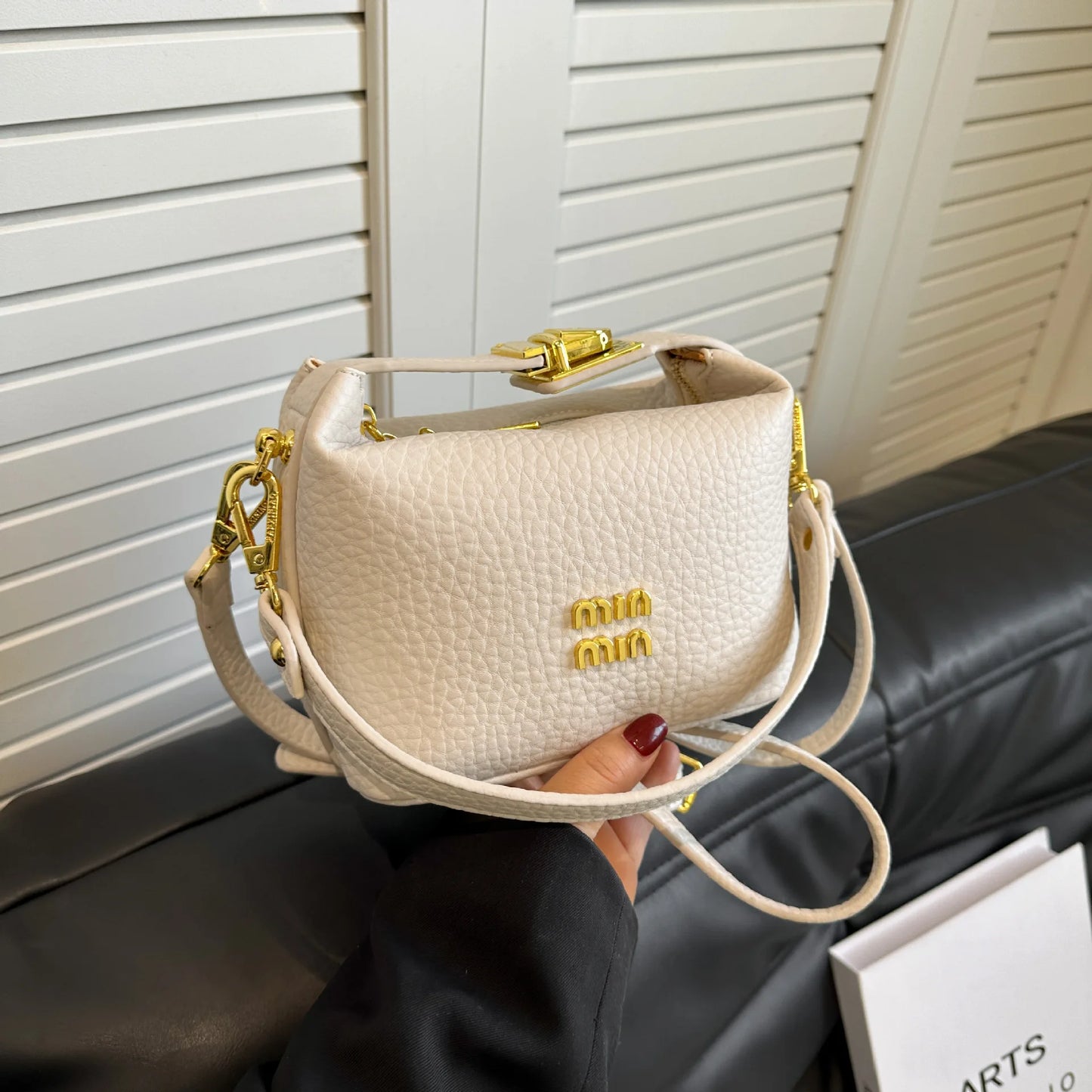 2025 Luxury high-end designer lunch box style shoulder/cross-body messenger bag with a lychee pattern .