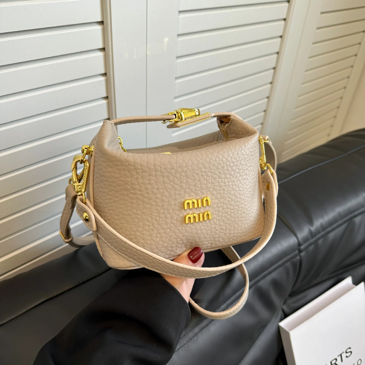2025 Luxury high-end designer lunch box style shoulder/cross-body messenger bag with a lychee pattern .